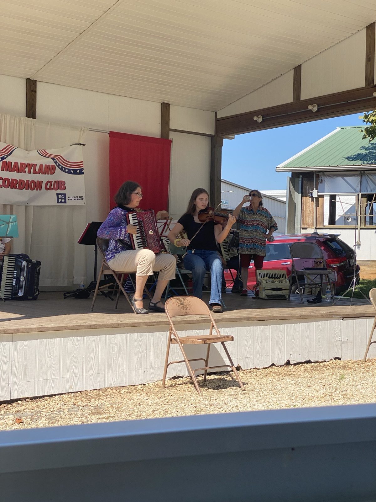 Allison playing accordion with the Maryland Accordion Club at an outdoor performance